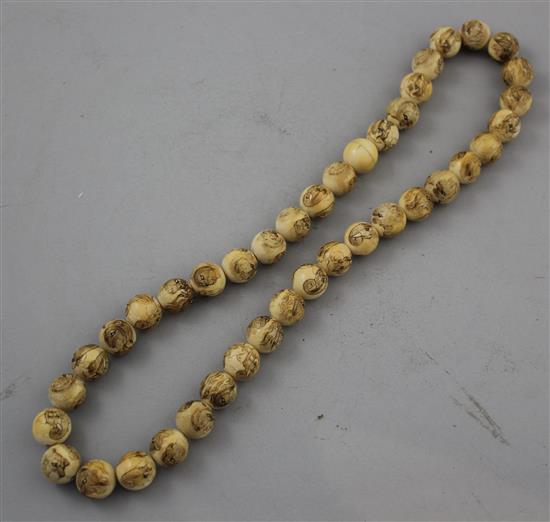Two Japanese carved ivory necklaces, early 20th century,